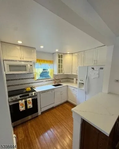 a kitchen with stainless steel appliances a stove a sink and a refrigerator