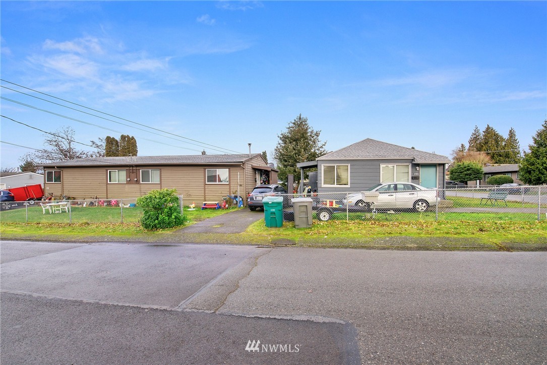 2906 Northeast 6th Place Renton, WA 98056 - Photo 2 of 21 a front view of a house with a yard and a garage