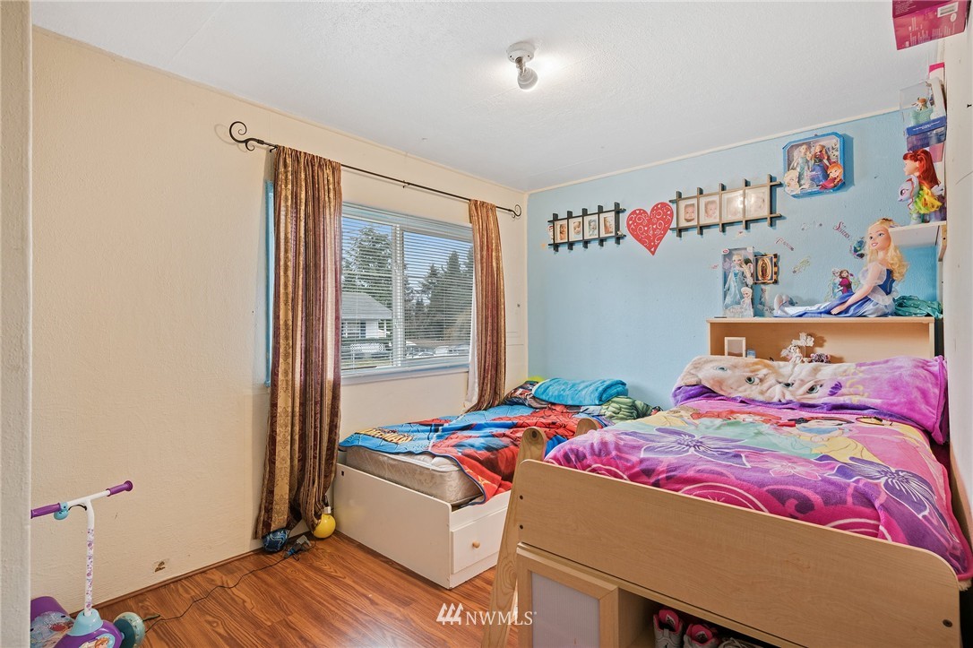 2906 Northeast 6th Place Renton, WA 98056 - Photo 13 of 21 a bedroom with a bed and a window