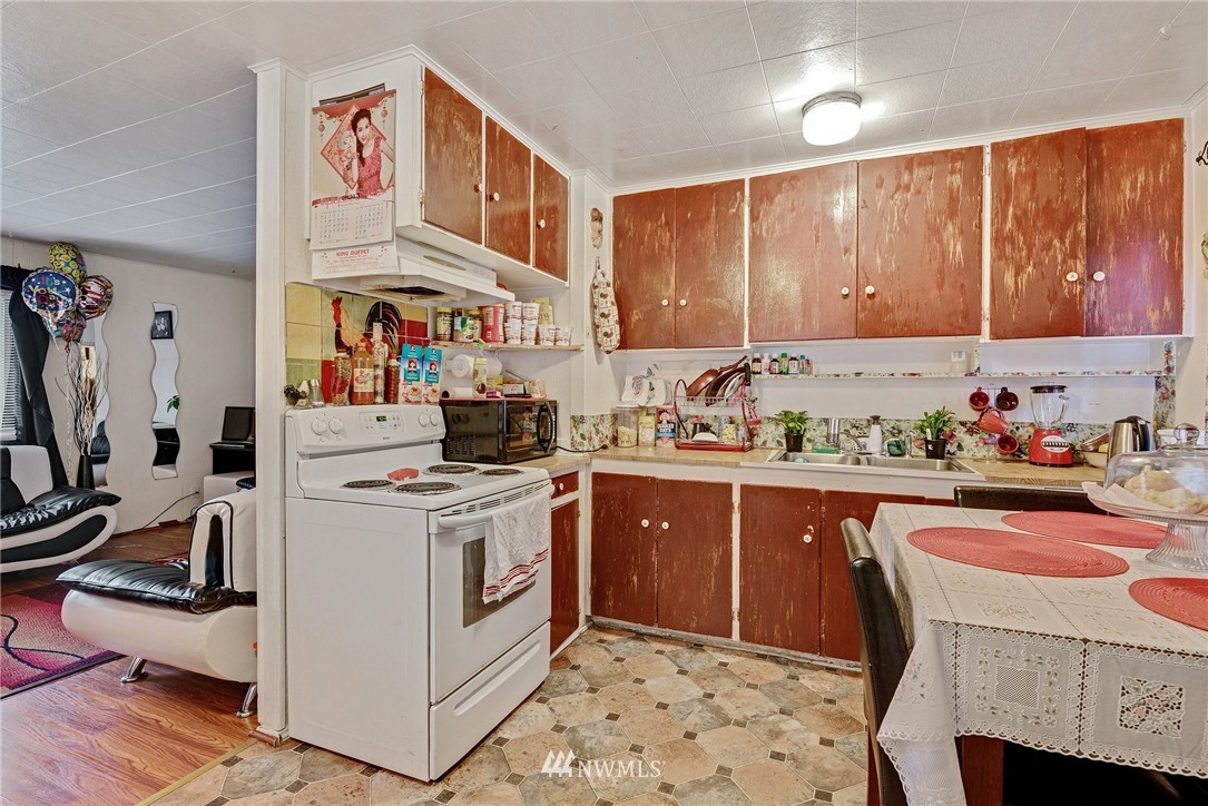 2906 Northeast 6th Place Renton, WA 98056 - Photo 16 of 21 a kitchen with a cabinets and white appliances