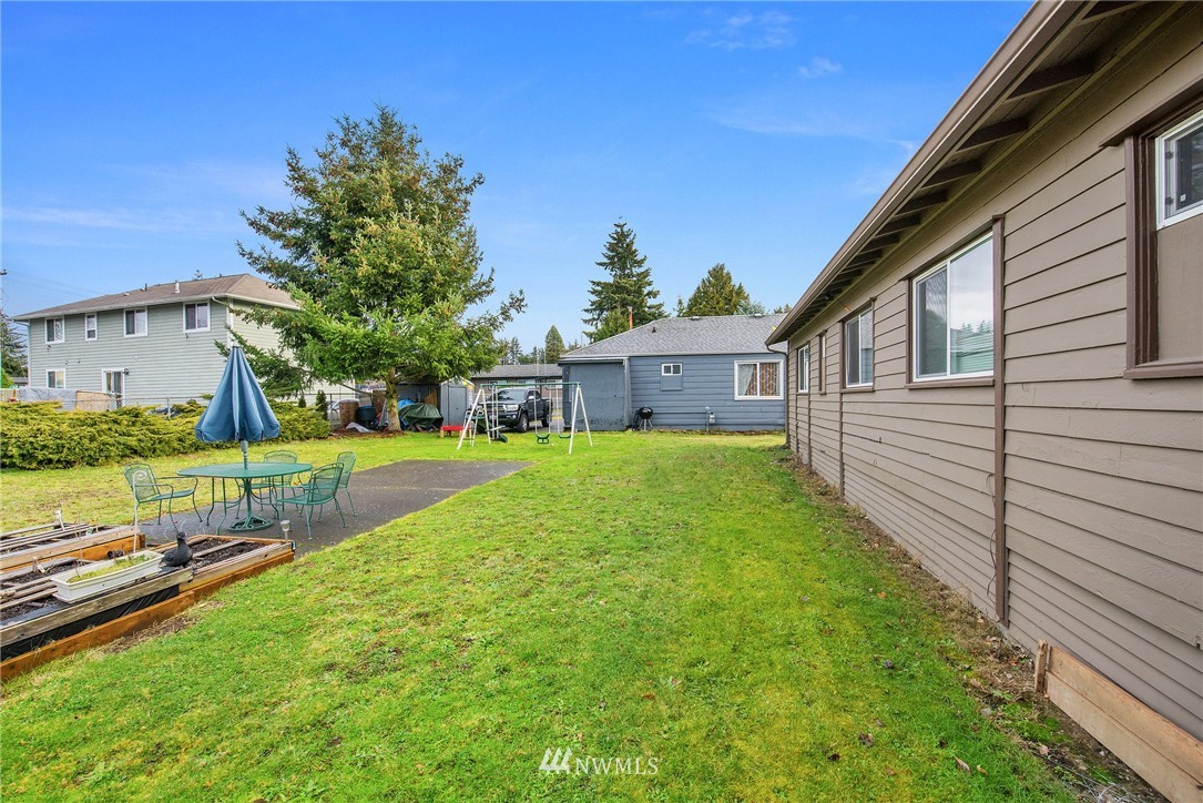 2906 Northeast 6th Place Renton, WA 98056 - Photo 6 of 21 a view of house with backyard and a patio