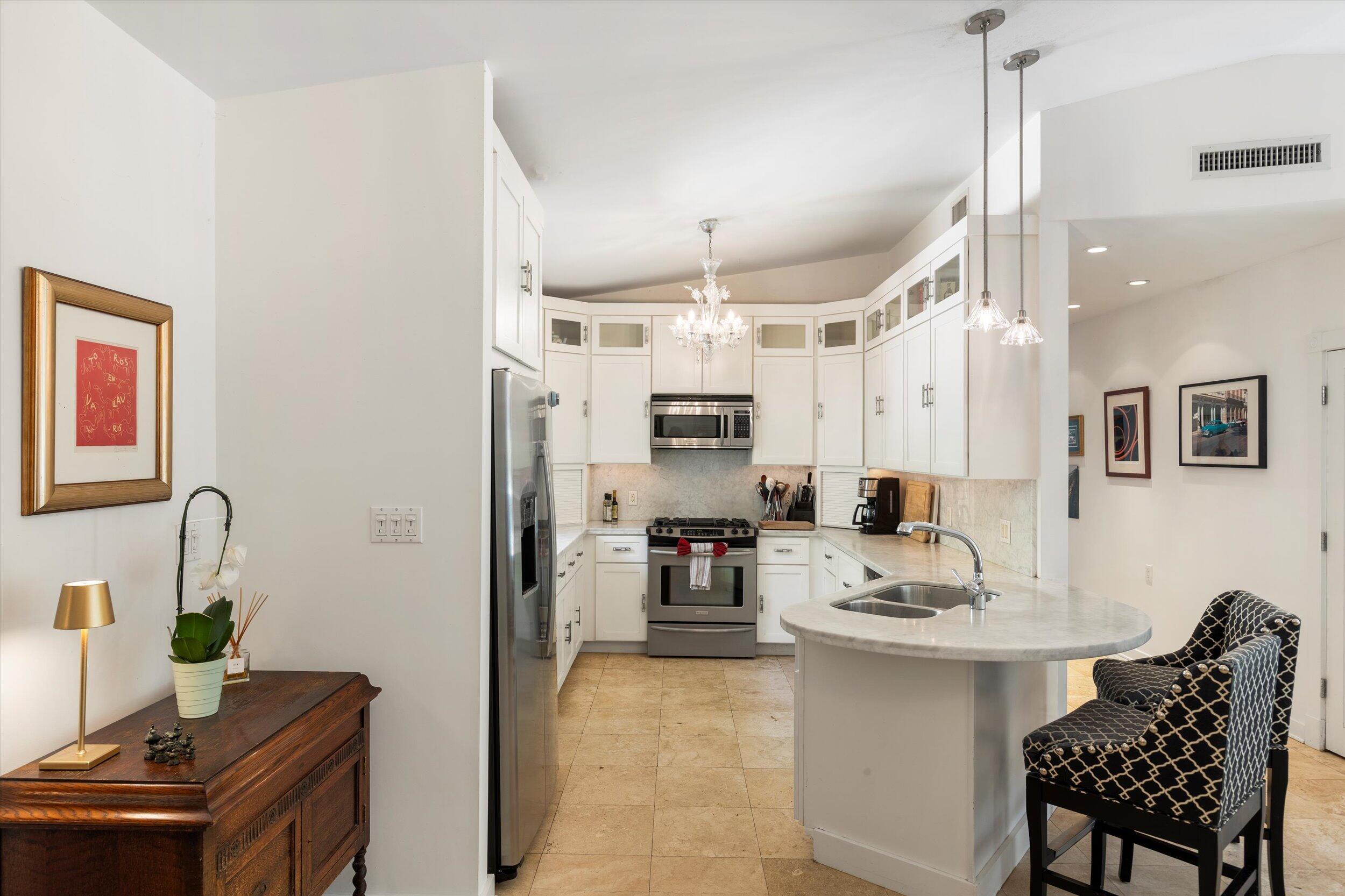 1719 Laird Street Key West, FL 33040 - Photo 13 of 39 a kitchen with a refrigerator and a dining table