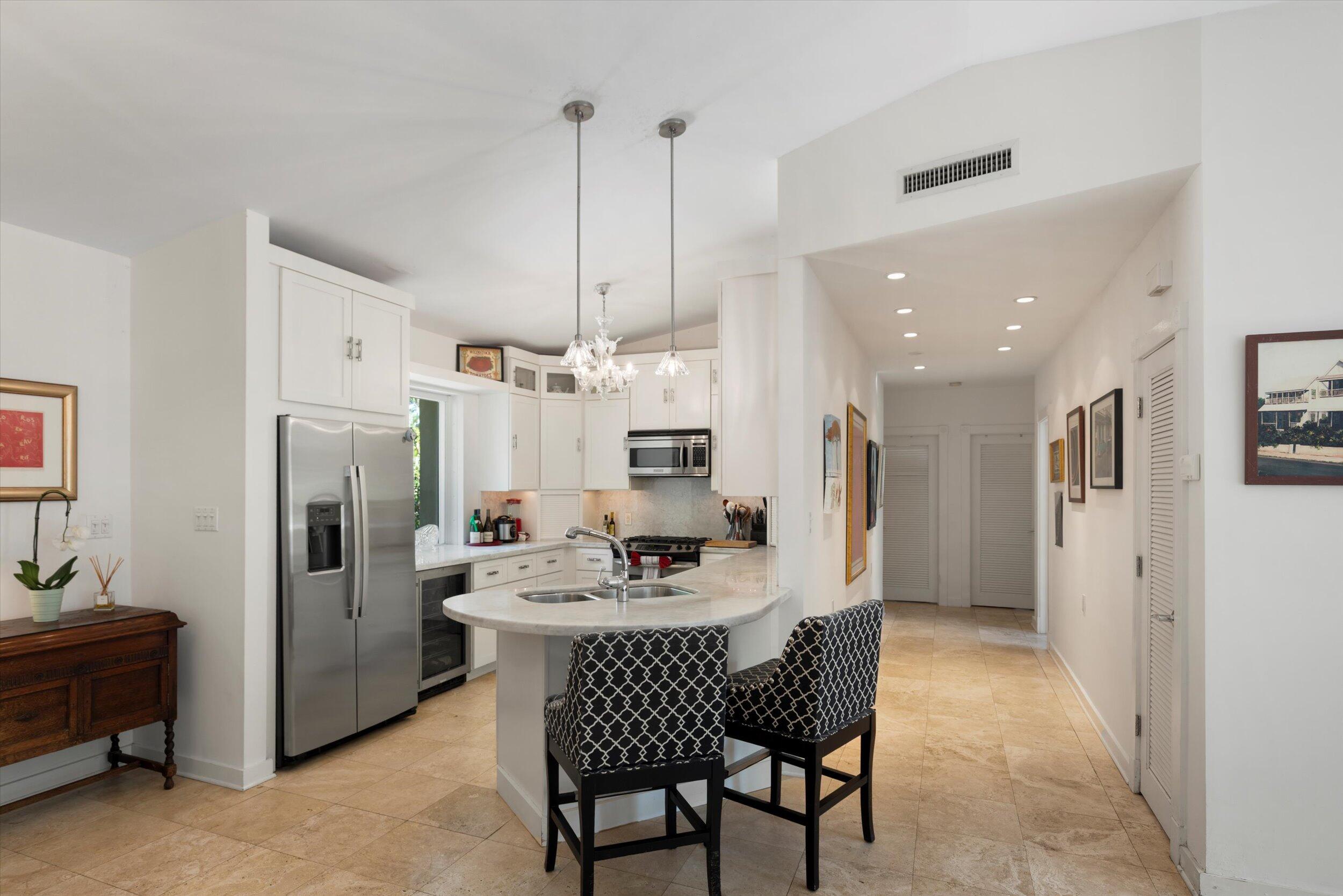 1719 Laird Street Key West, FL 33040 - Photo 14 of 39 a kitchen with stainless steel appliances kitchen island granite countertop a refrigerator a sink a stove a dining table and chairs