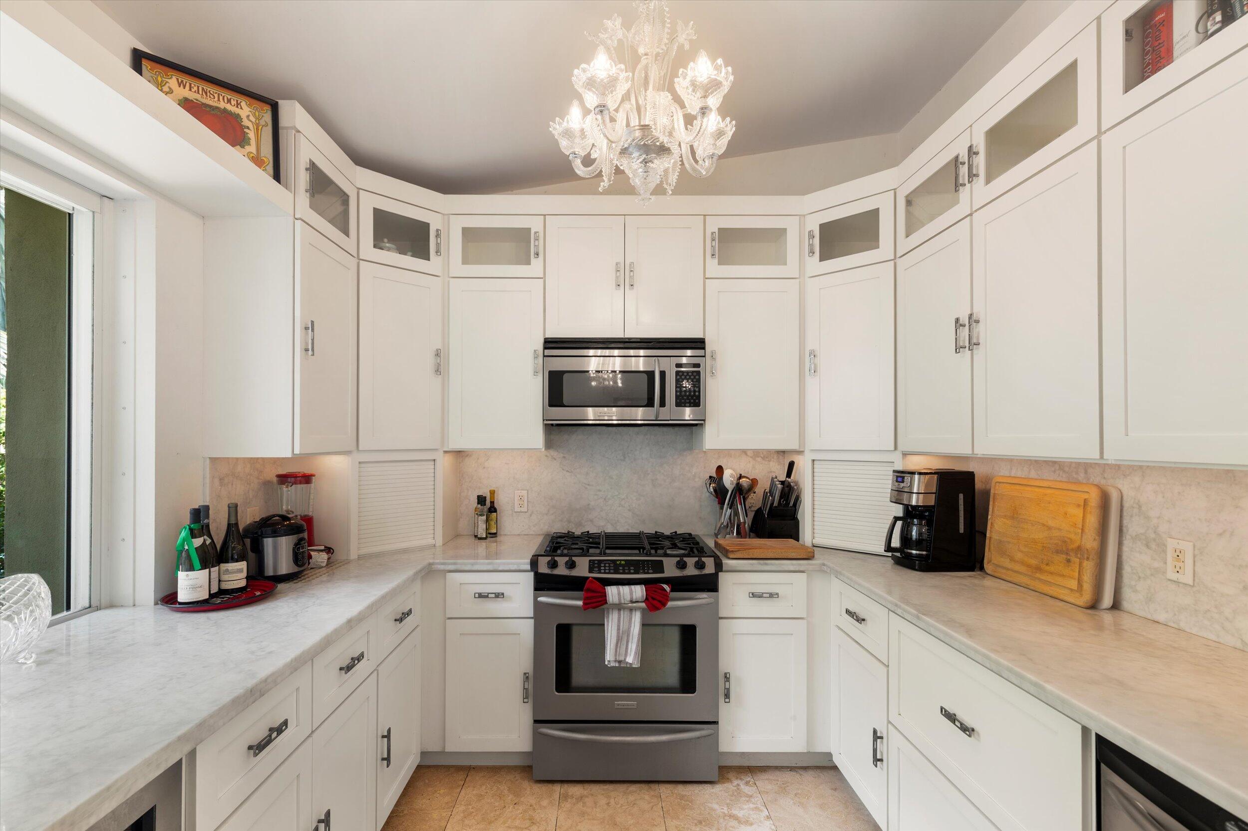 1719 Laird Street Key West, FL 33040 - Photo 16 of 39 a kitchen with stainless steel appliances granite countertop a sink a stove and a refrigerator
