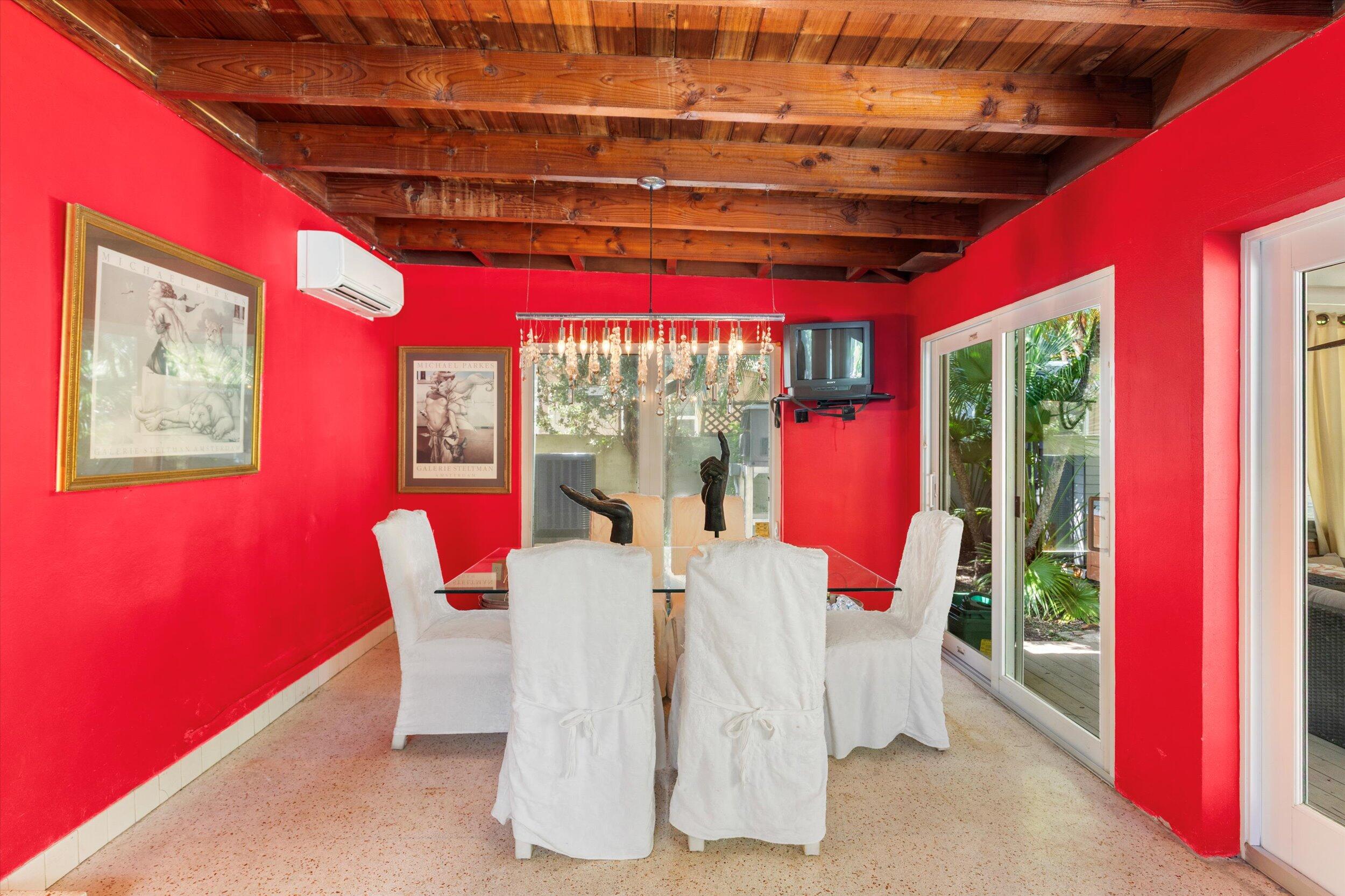 1719 Laird Street Key West, FL 33040 - Photo 20 of 39 a view of a dining room with furniture a chandelier and large windows
