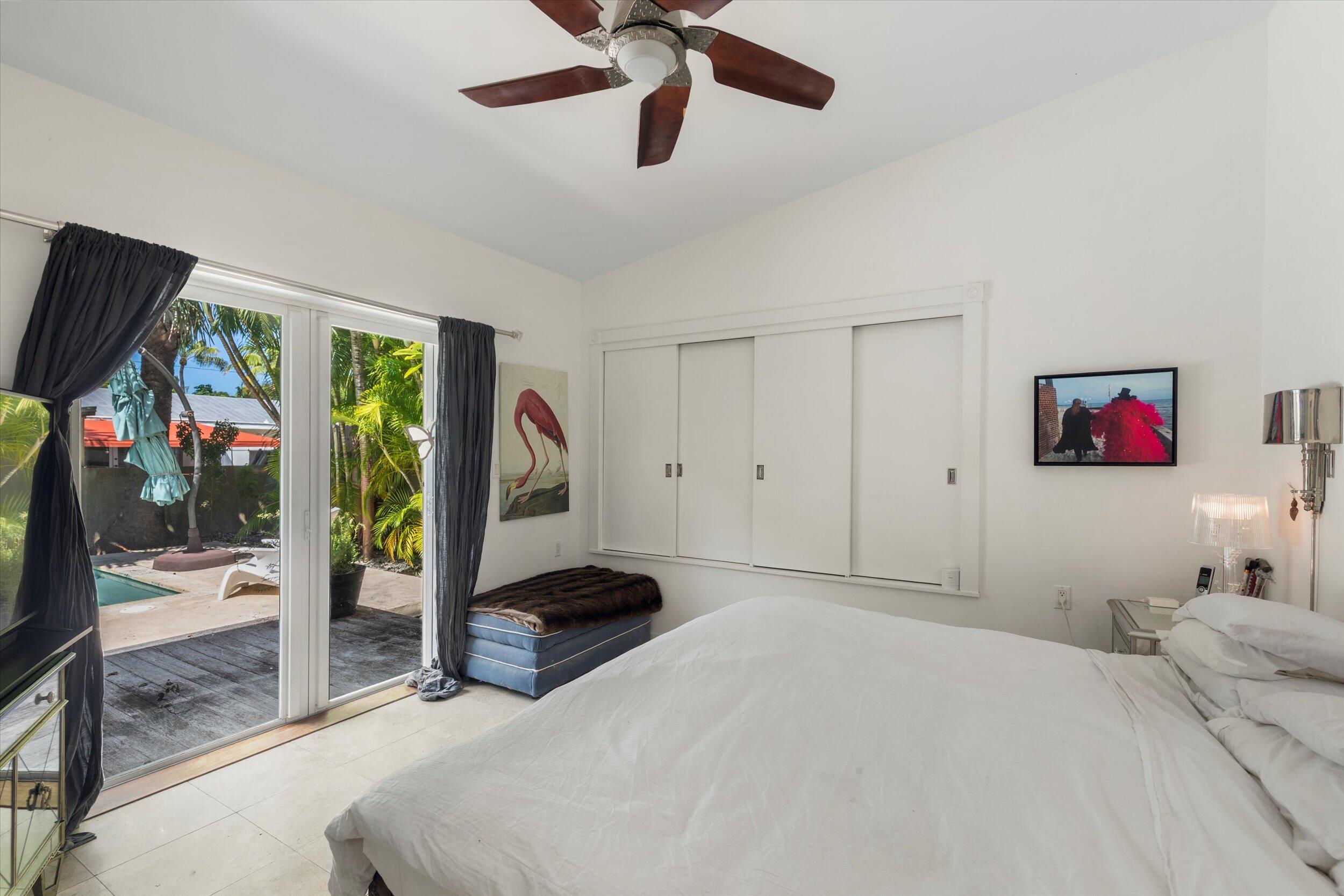 1719 Laird Street Key West, FL 33040 - Photo 28 of 39 a bedroom with a bed and a flat screen tv