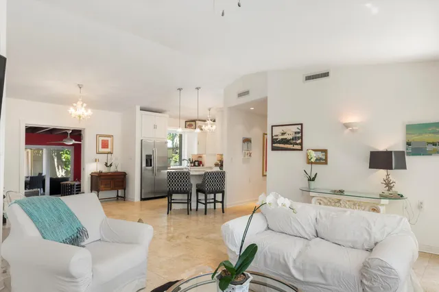 a living room with furniture and a view of kitchen