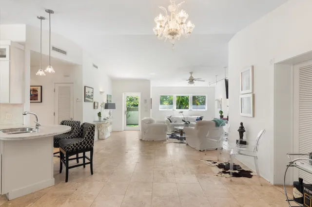a living room with furniture chandelier and a chandelier