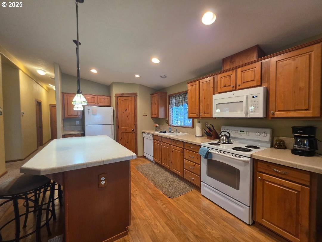 190 North Sentosa Lake Road Tygh Valley, OR 97063 - Photo 14 of 45 a kitchen with stainless steel appliances granite countertop a sink stove and refrigerator