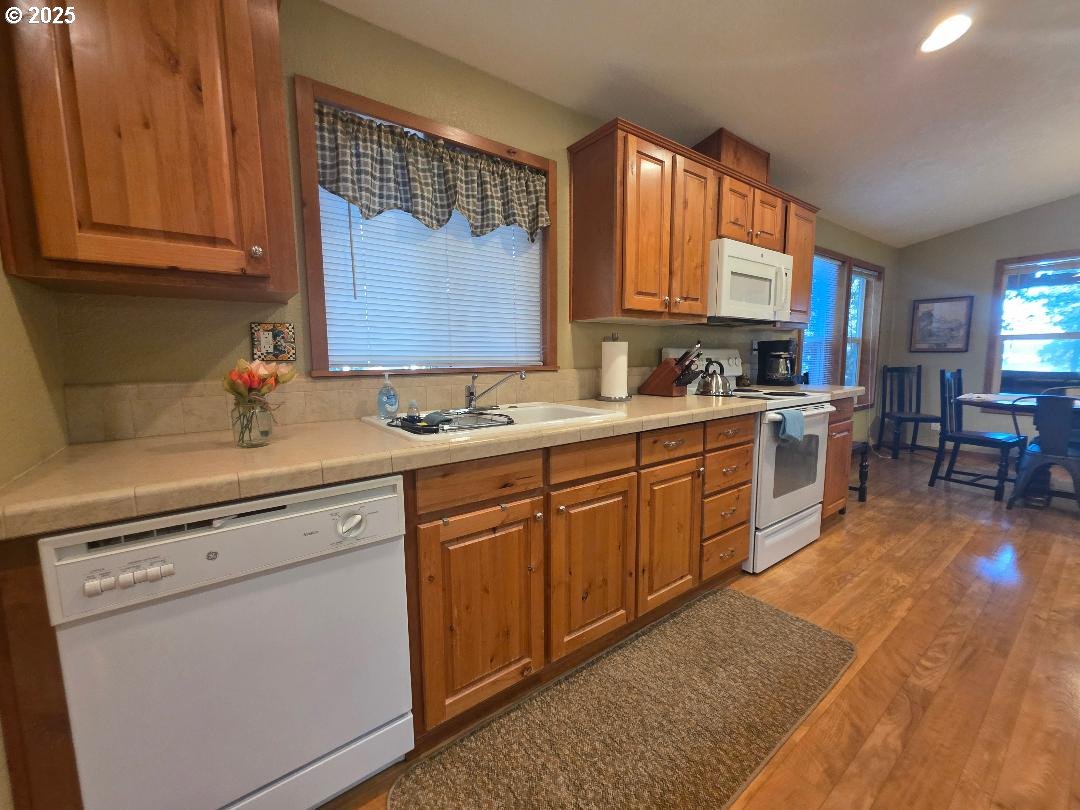 190 North Sentosa Lake Road Tygh Valley, OR 97063 - Photo 20 of 45 a kitchen with a sink stove and cabinets