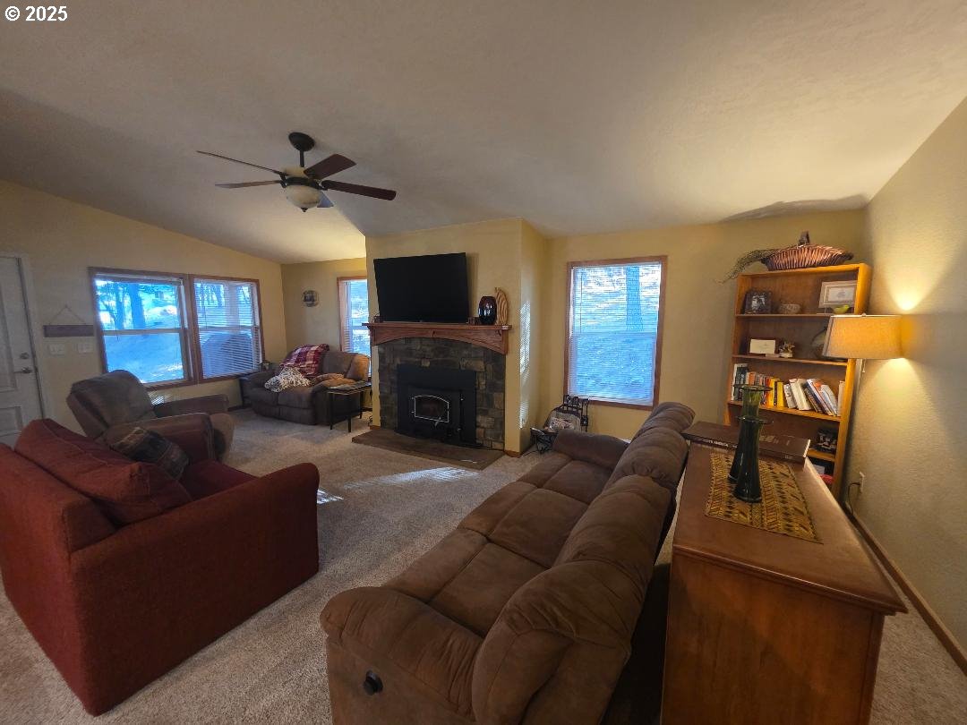 190 North Sentosa Lake Road Tygh Valley, OR 97063 - Photo 26 of 45 a living room with furniture a flat screen tv and a fireplace