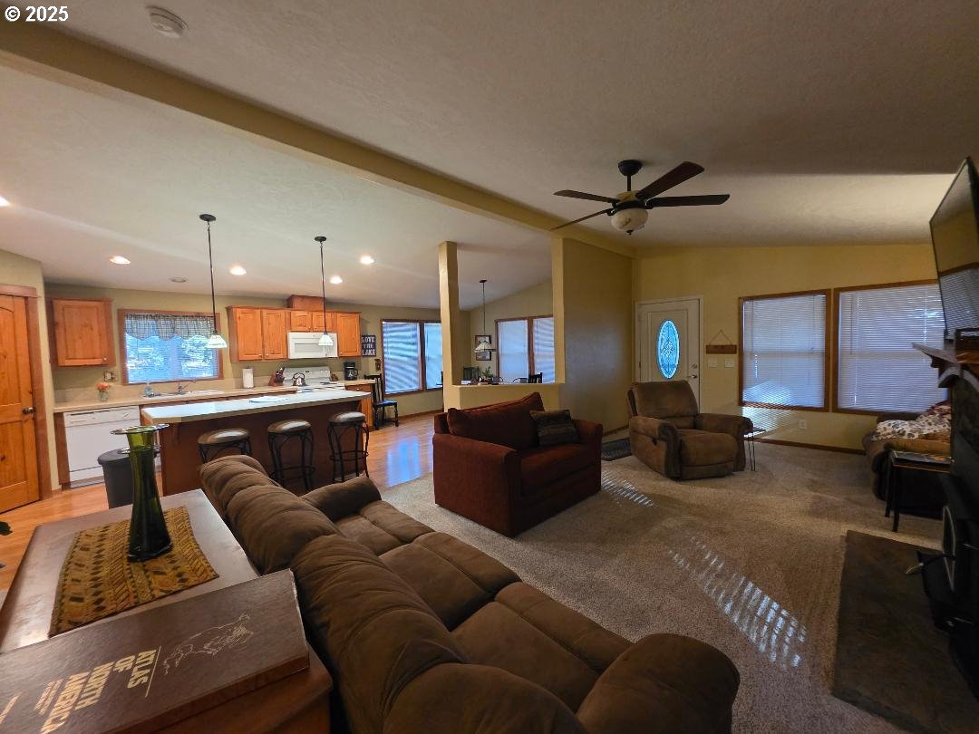 190 North Sentosa Lake Road Tygh Valley, OR 97063 - Photo 27 of 45 a living room with furniture kitchen view and a chandelier