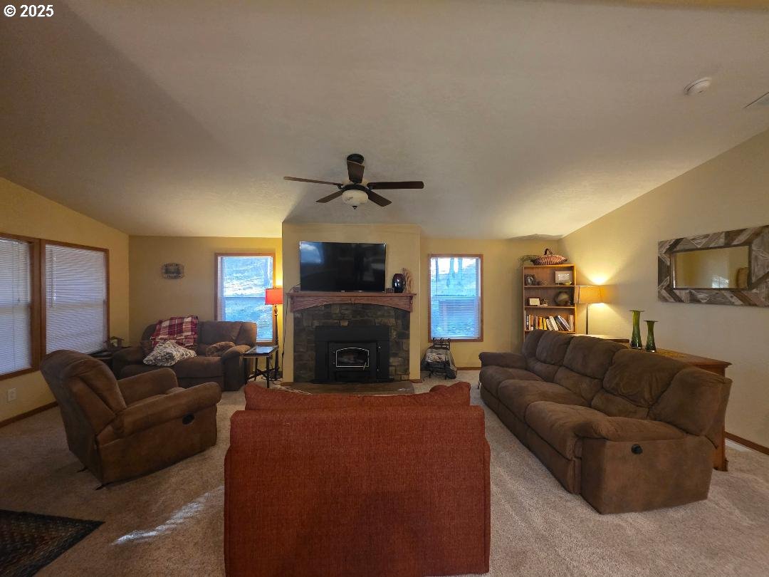 190 North Sentosa Lake Road Tygh Valley, OR 97063 - Photo 30 of 45 a living room with furniture a fireplace and a flat screen tv