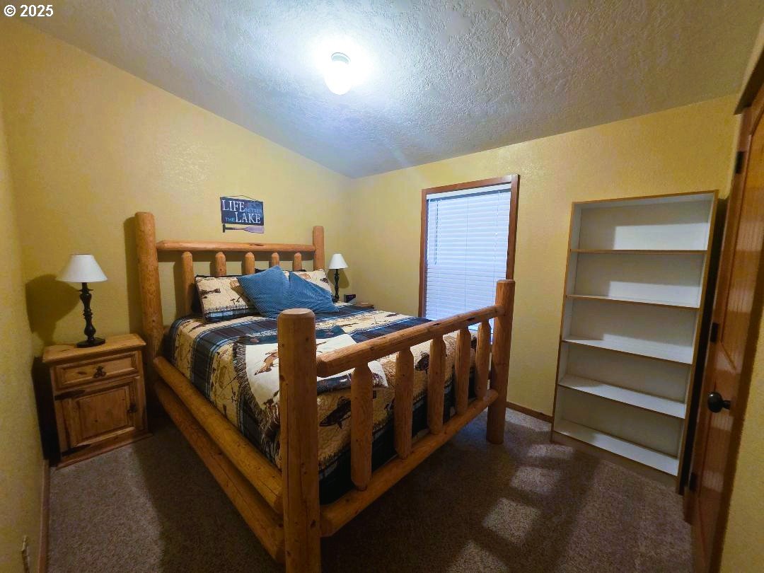 190 North Sentosa Lake Road Tygh Valley, OR 97063 - Photo 32 of 45 a bed sitting in a room next to a window