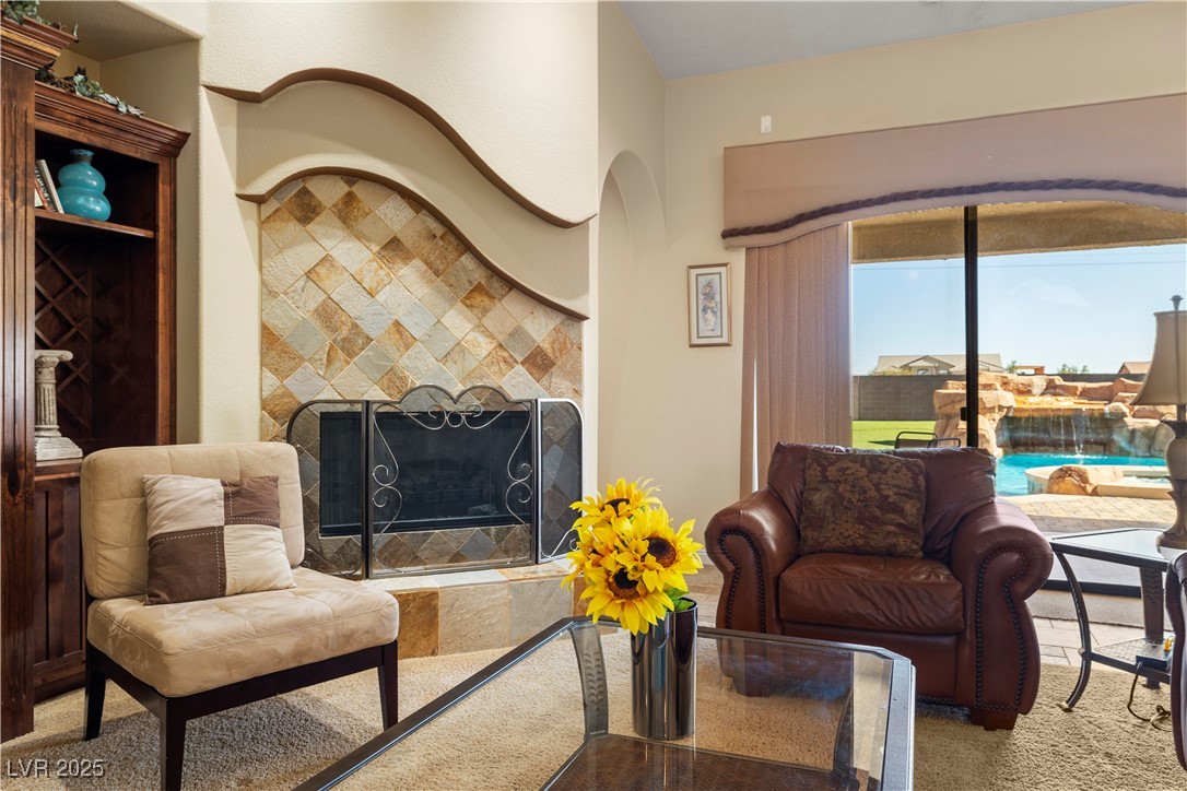 2181 Winery Road Pahrump, NV 89048 - Photo 19 of 73 Lovely detailed fireplace with views of the pool and waterfall!