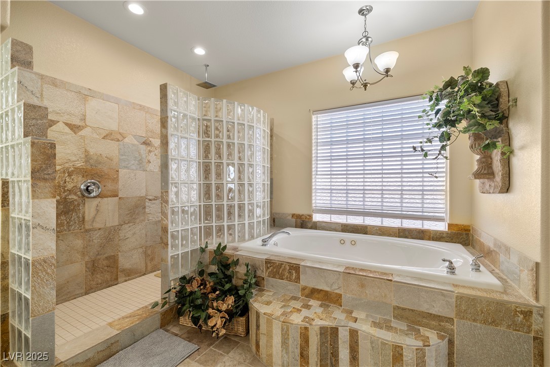 2181 Winery Road Pahrump, NV 89048 - Photo 40 of 73 Jetted bathtub and Walk In shower featuring a rain shower head with a traditional one as well.