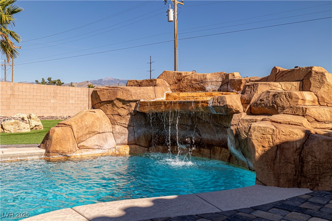 2181 Winery Road Pahrump, NV 89048 - Photo 58 of 73 Grotto area located under the waterfall with views of Mount Charleston peaking over the block fence.