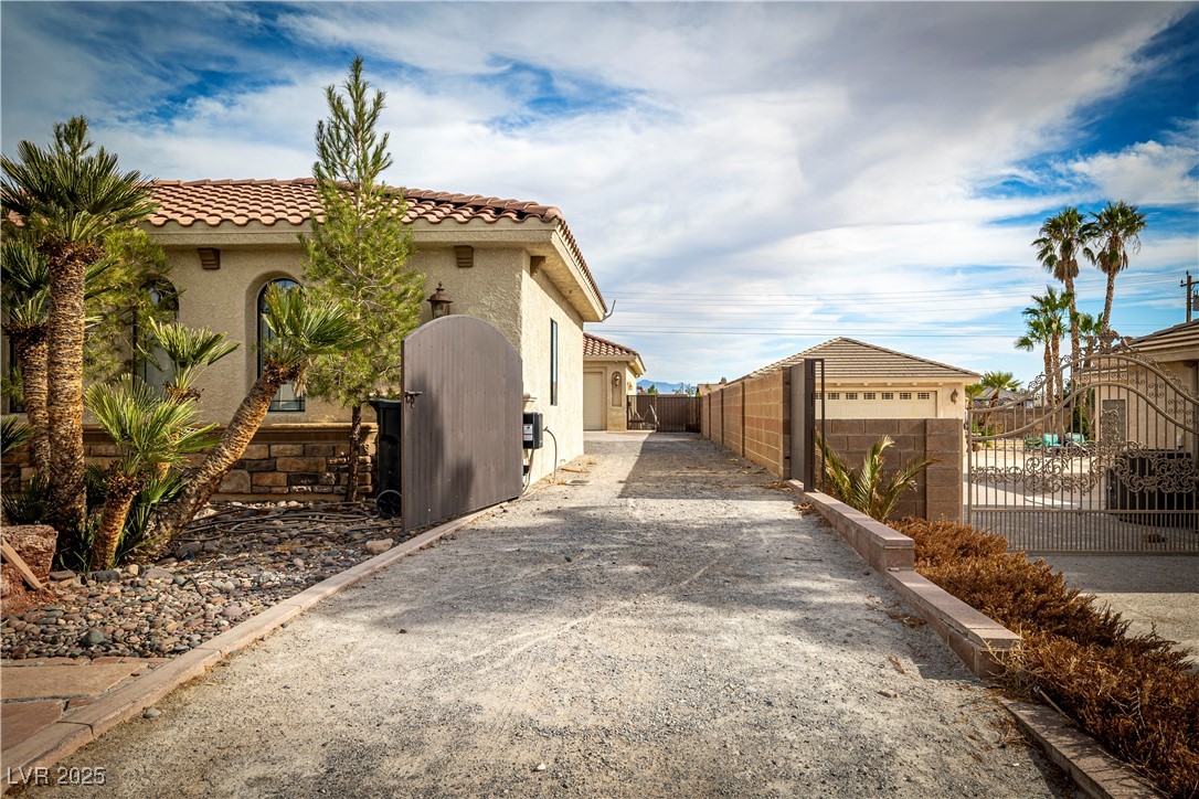 2181 Winery Road Pahrump, NV 89048 - Photo 7 of 73 Auto Wrought Iron gate to the entrance of the detached garage and RV parking.