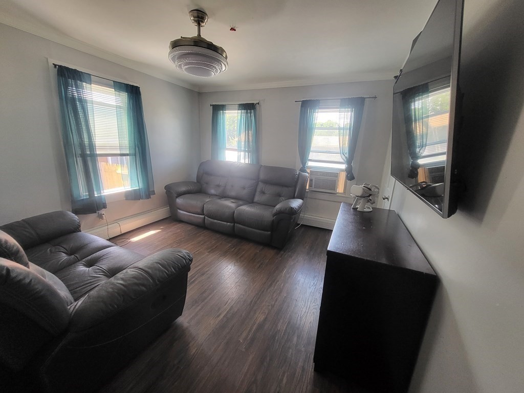 28 Frederick Street New Bedford, MA 02744 - Photo 14 of 29 a living room with furniture and a flat screen tv