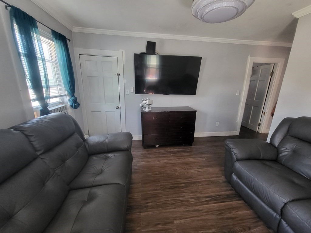 28 Frederick Street New Bedford, MA 02744 - Photo 15 of 29 a living room with furniture and a flat screen tv