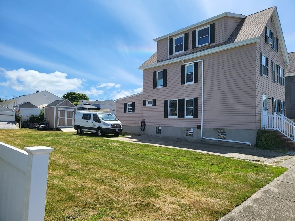 28 Frederick Street New Bedford, MA 02744 - Photo 2 of 29 a front view of a house with a yard table and chairs