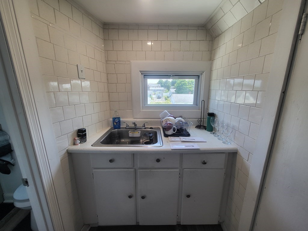 28 Frederick Street New Bedford, MA 02744 - Photo 25 of 29 a bathroom with a sink a toilet and vanity