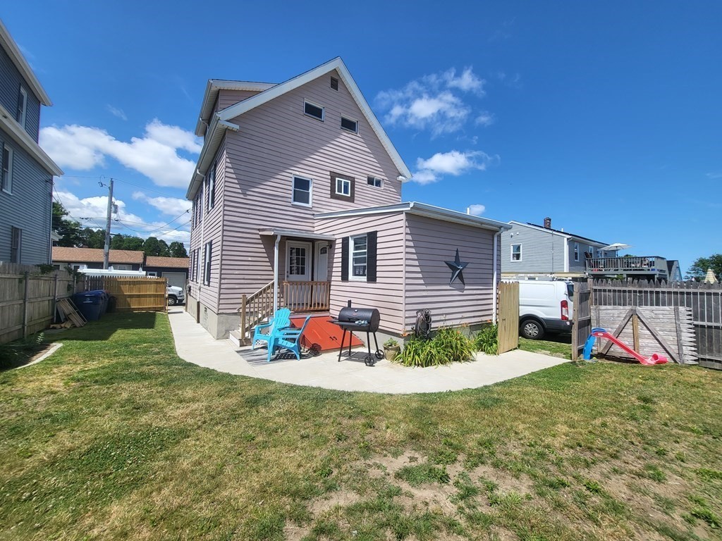 28 Frederick Street New Bedford, MA 02744 - Photo 4 of 29 a front view of a house with a yard