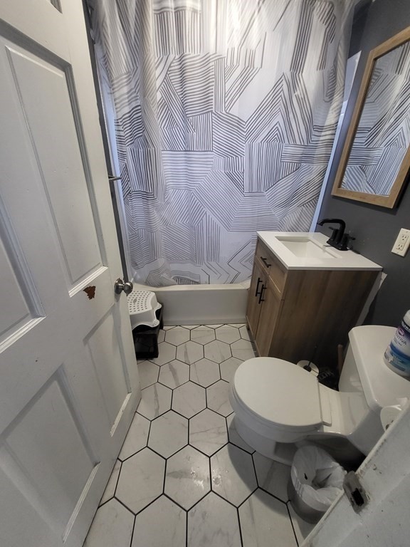 28 Frederick Street New Bedford, MA 02744 - Photo 10 of 29 a white toilet sitting next to a small bathroom