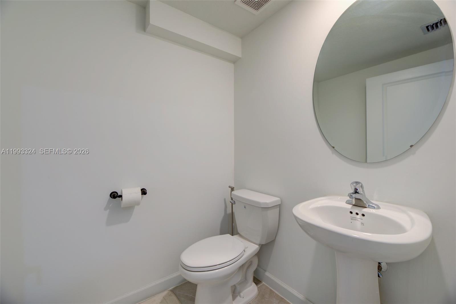 12604 Northwest 23rd Place Miami, FL 33167 - Photo 18 of 39 a bathroom with a sink toilet and a mirror