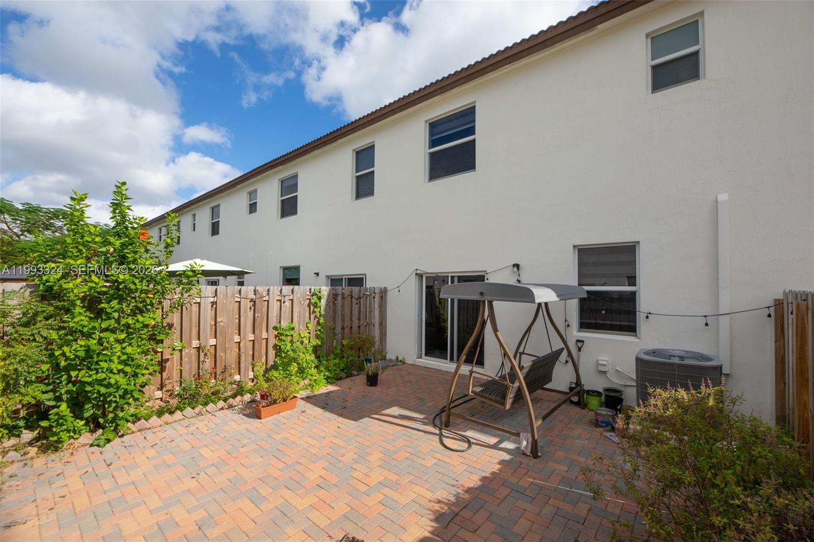 12604 Northwest 23rd Place Miami, FL 33167 - Photo 20 of 39 a view of a patio with table and chairs and potted plants