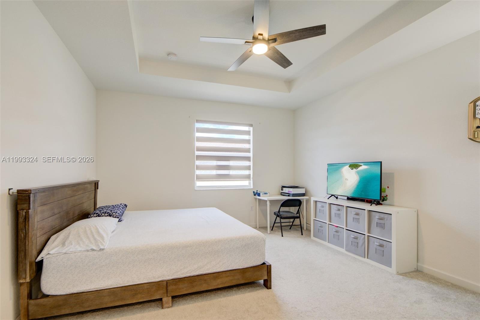 12604 Northwest 23rd Place Miami, FL 33167 - Photo 21 of 39 a spacious bedroom with a bed and a flat screen tv