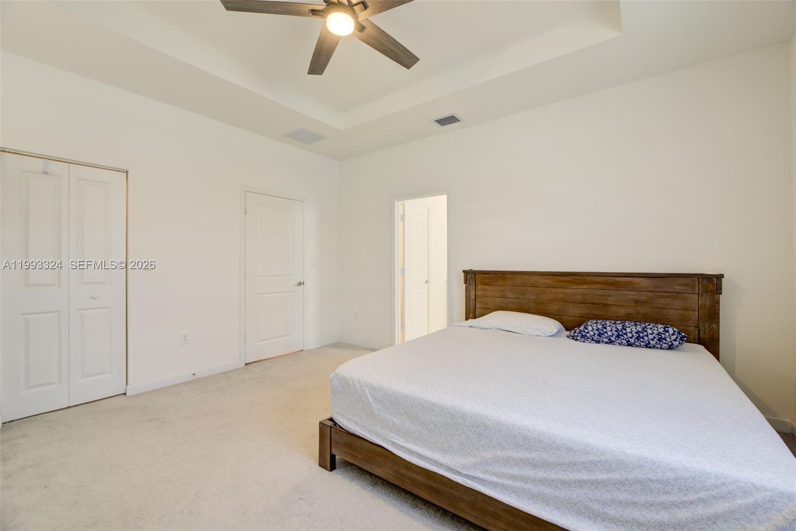 12604 Northwest 23rd Place Miami, FL 33167 - Photo 23 of 39 a bedroom with a bed and a ceiling fan