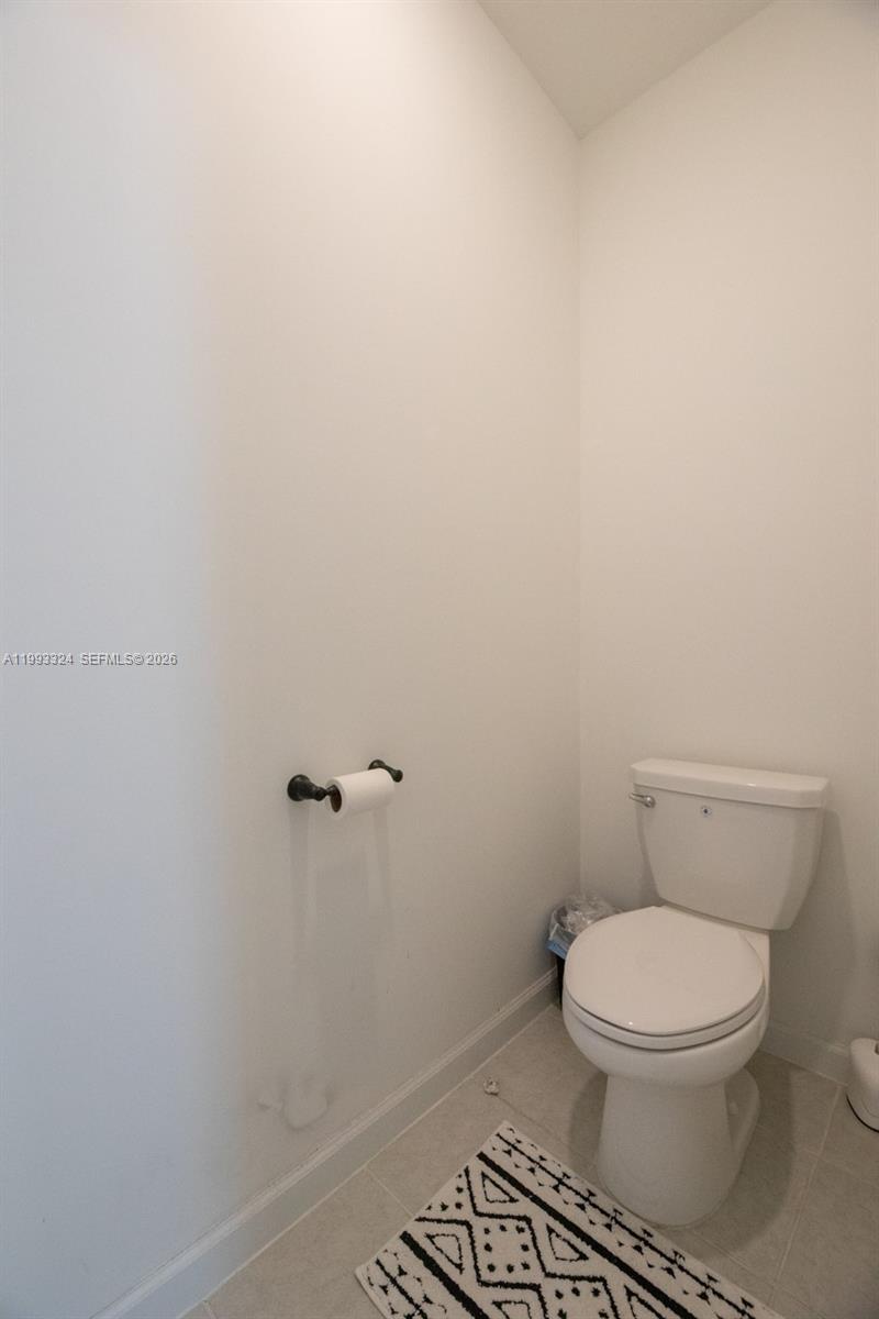 12604 Northwest 23rd Place Miami, FL 33167 - Photo 25 of 39 a white toilet sitting next to a shower