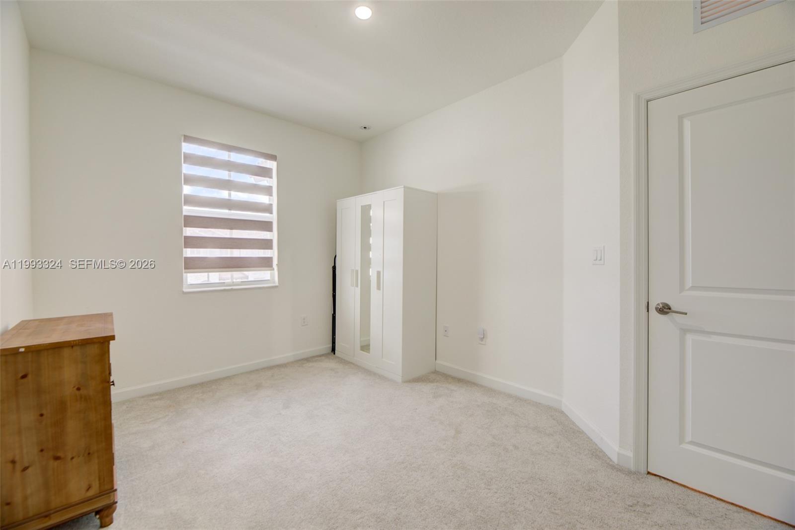 12604 Northwest 23rd Place Miami, FL 33167 - Photo 27 of 39 a view of an empty room with a window