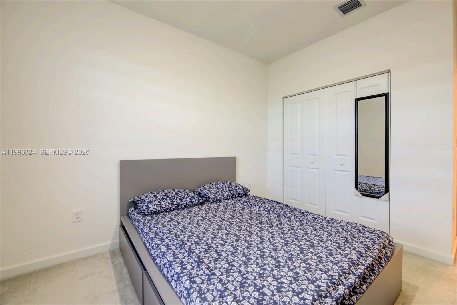 12604 Northwest 23rd Place Miami, FL 33167 - Photo 32 of 39 a bedroom with a bed and wooden floor
