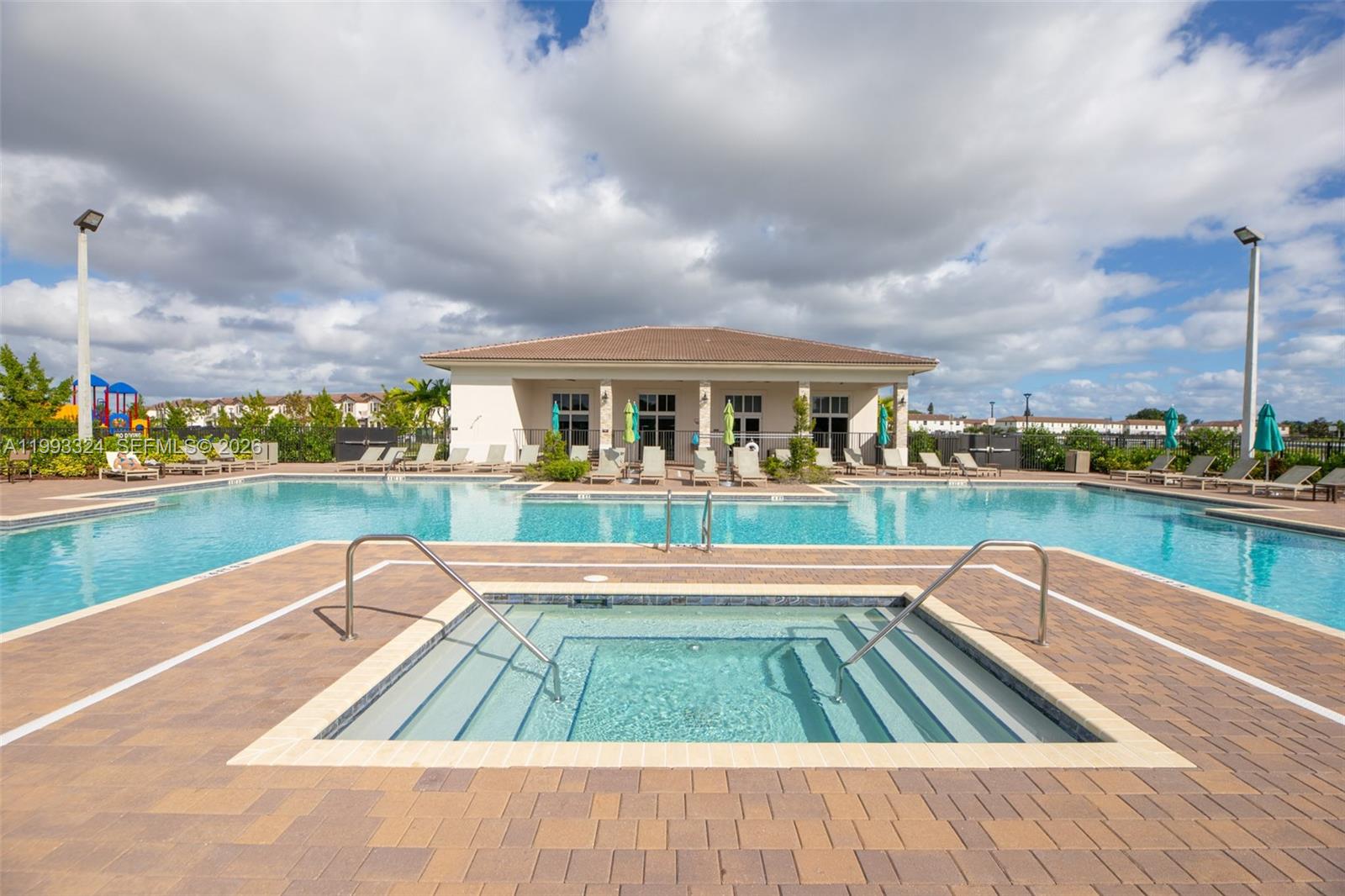12604 Northwest 23rd Place Miami, FL 33167 - Photo 36 of 39 a view of swimming pool that has lawn chairs with plants