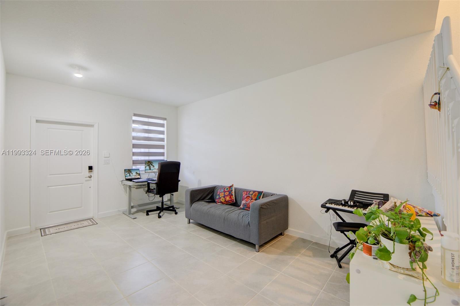 12604 Northwest 23rd Place Miami, FL 33167 - Photo 4 of 39 a living room with furniture flowerpot and a window