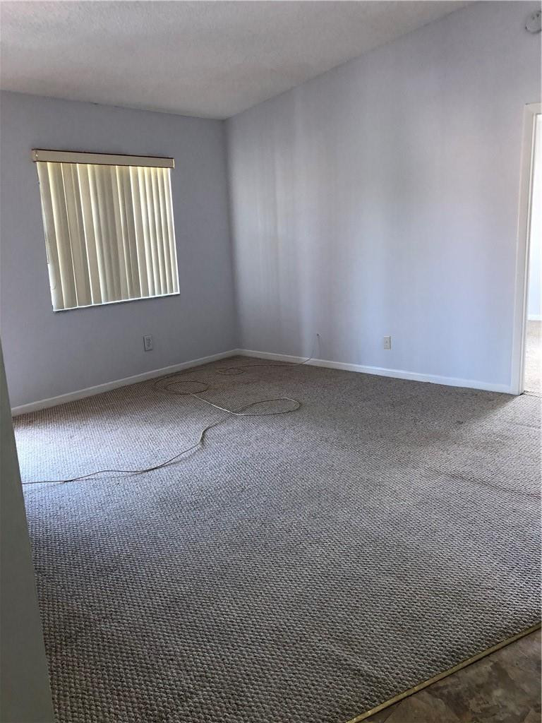 9466 Boca Cove Circle, Unit 313 Boca Raton, FL 33428 - Photo 4 of 7 an empty room with windows