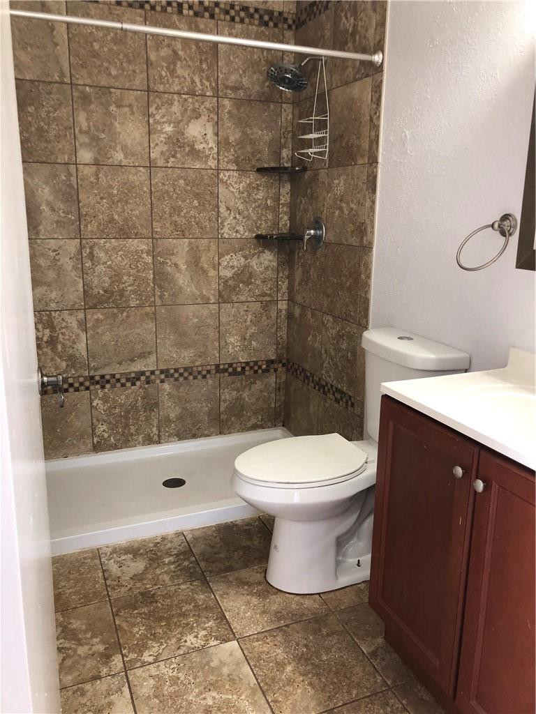 9466 Boca Cove Circle, Unit 313 Boca Raton, FL 33428 - Photo 6 of 7 a bathroom with a toilet and a shower