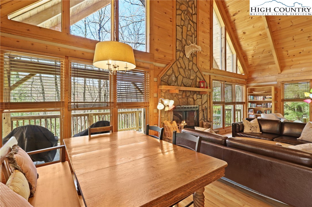 291 Dream Forest Path Banner Elk, NC 28604 - Photo 11 of 43 a view of a balcony with dining table and chairs