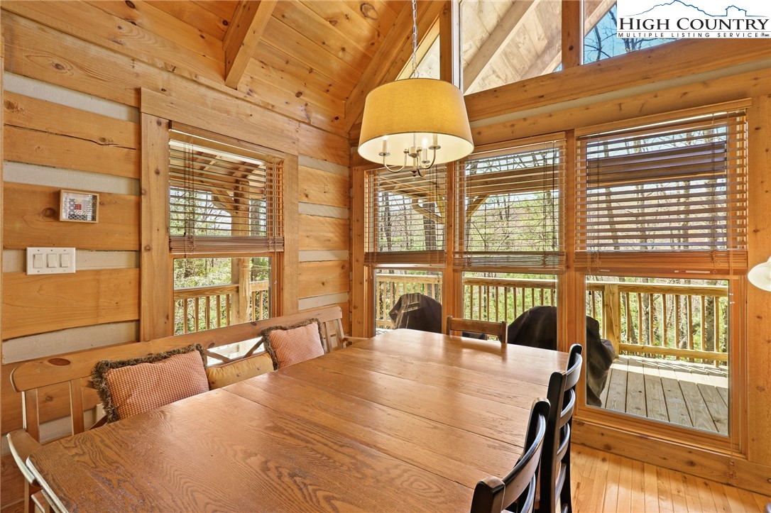 291 Dream Forest Path Banner Elk, NC 28604 - Photo 12 of 43 a view of a dining room with furniture large windows and wooden floor