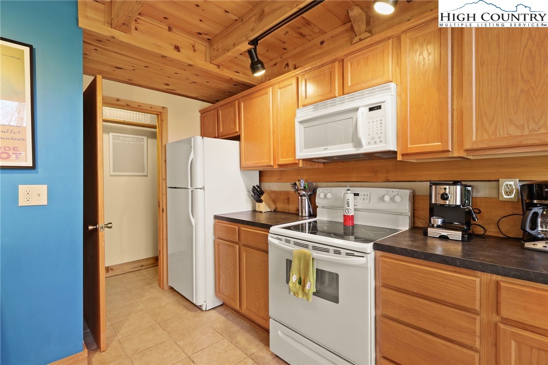 291 Dream Forest Path Banner Elk, NC 28604 - Photo 16 of 43 a kitchen with a refrigerator sink and cabinets