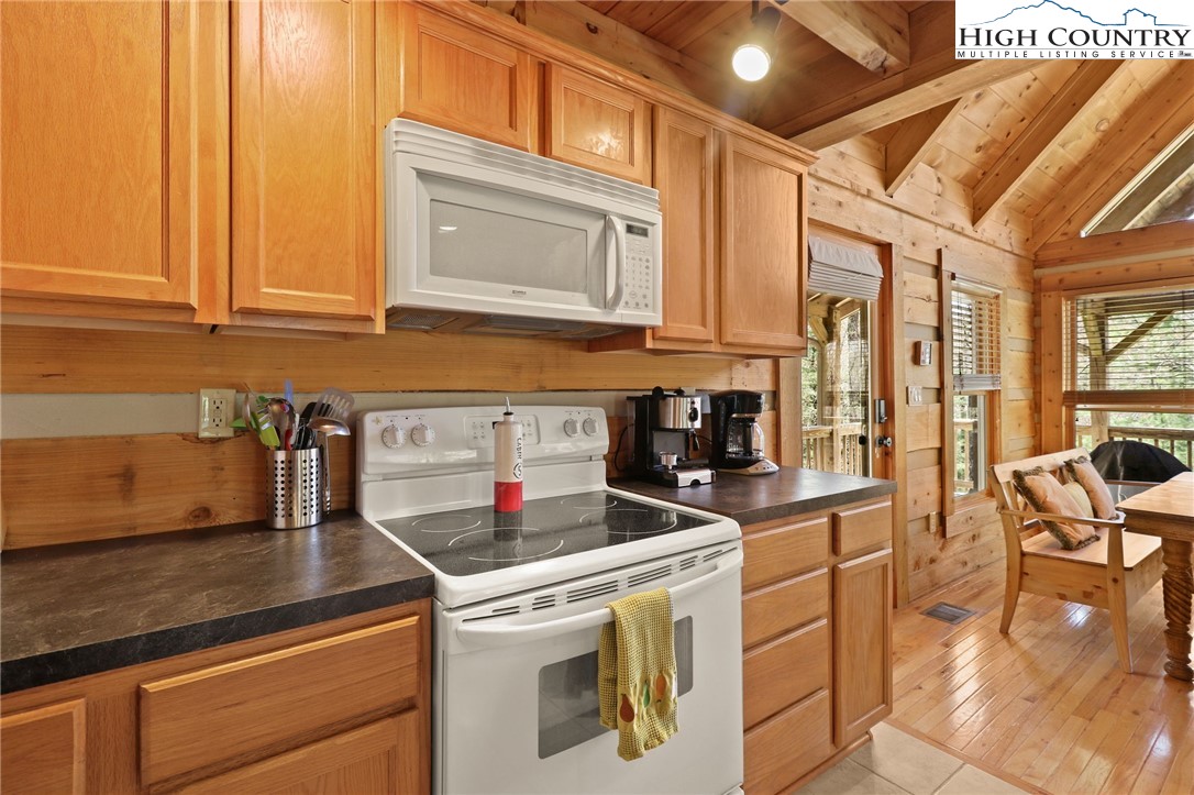 291 Dream Forest Path Banner Elk, NC 28604 - Photo 18 of 43 a kitchen with stainless steel appliances granite countertop a stove a sink and a microwave