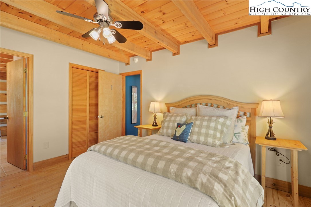 291 Dream Forest Path Banner Elk, NC 28604 - Photo 22 of 43 a bedroom with a bed and a chandelier