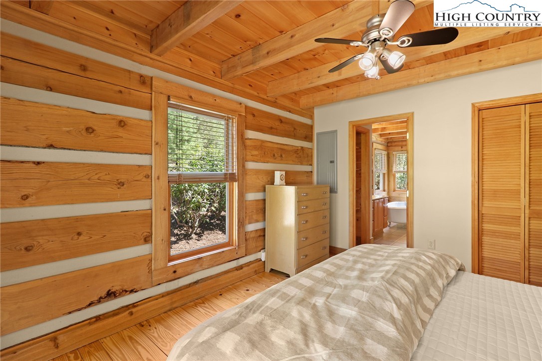 291 Dream Forest Path Banner Elk, NC 28604 - Photo 23 of 43 a bedroom with a large bed and a window