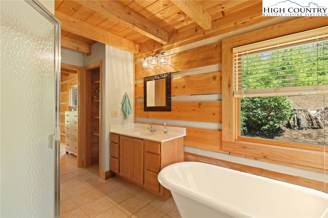 291 Dream Forest Path Banner Elk, NC 28604 - Photo 25 of 43 a bathroom with a tub sink and mirror