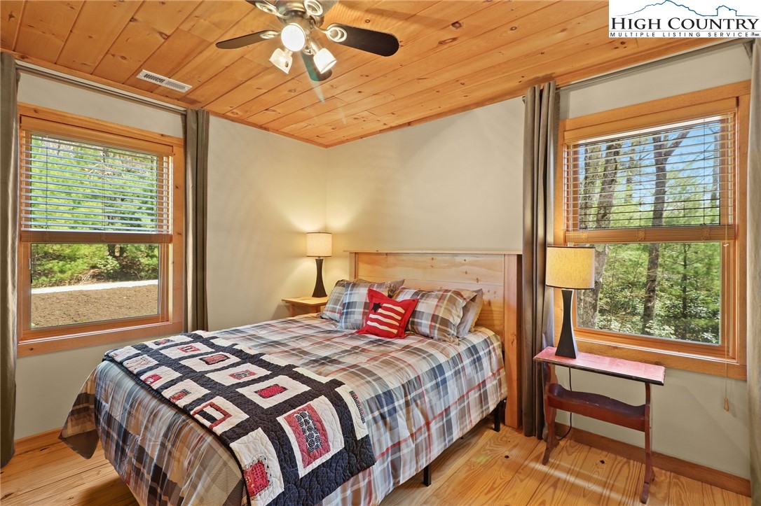 291 Dream Forest Path Banner Elk, NC 28604 - Photo 30 of 43 a bedroom with a large bed and a large window