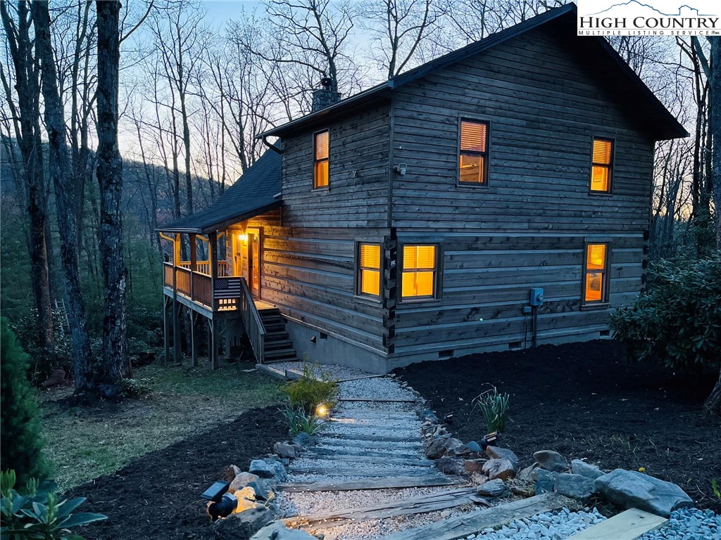 291 Dream Forest Path Banner Elk, NC 28604 - Photo 3 of 43 a backyard of a house with barbeque oven table and chairs