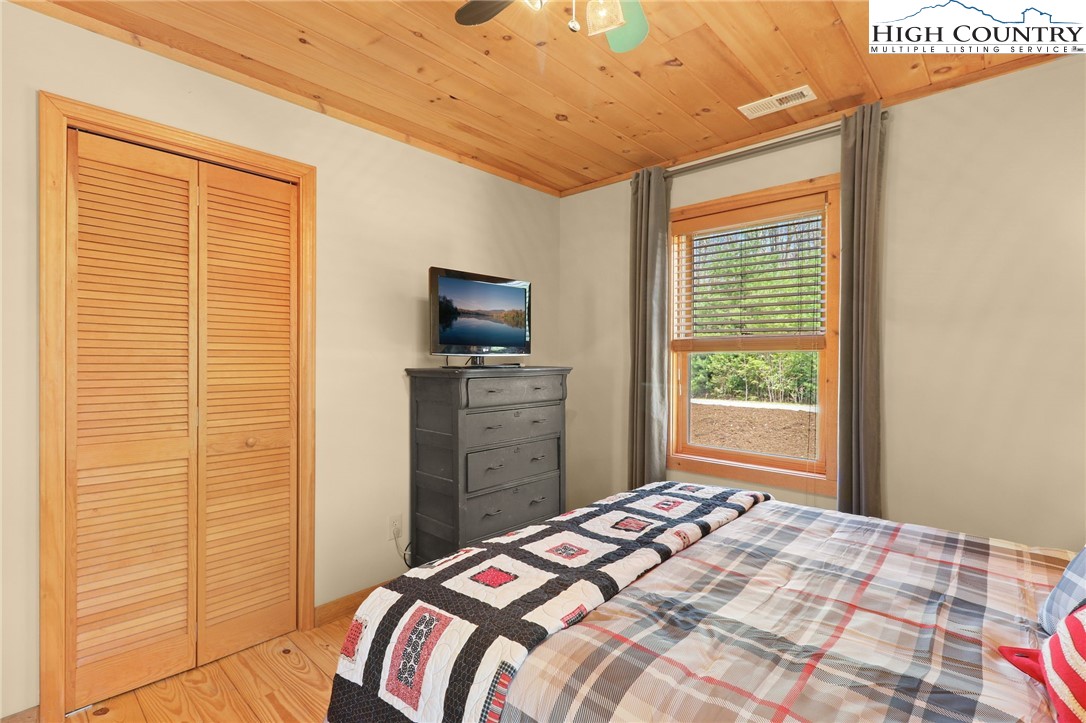 291 Dream Forest Path Banner Elk, NC 28604 - Photo 31 of 43 a bedroom with a bed and a television