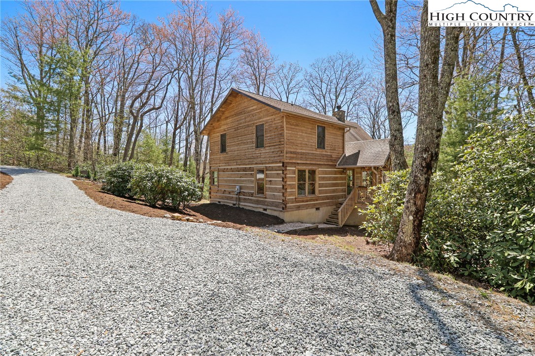 291 Dream Forest Path Banner Elk, NC 28604 - Photo 6 of 43 a view of a house with a yard covered in snow